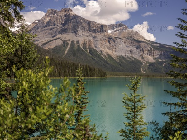 Emerald Lake with lush greenery and the rugged Canadian Rocky Mountains within Yoho National Park
