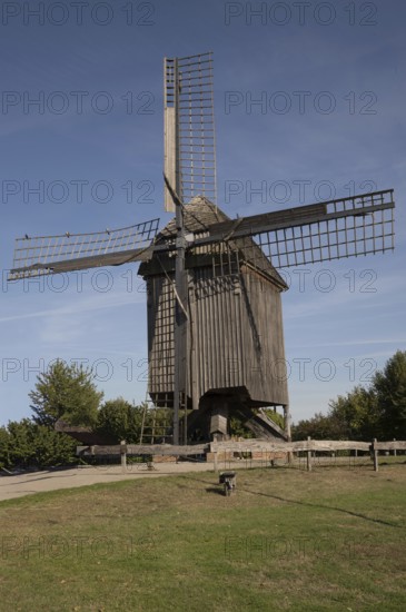 Borken, NRW, Germany, Historic wooden windmill featuring large sails, standing in a green field