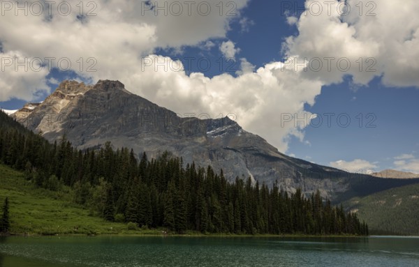 The Canadian Rocky Mountains and forests framing Emerald Lake with a sky full of clouds inside Yoho