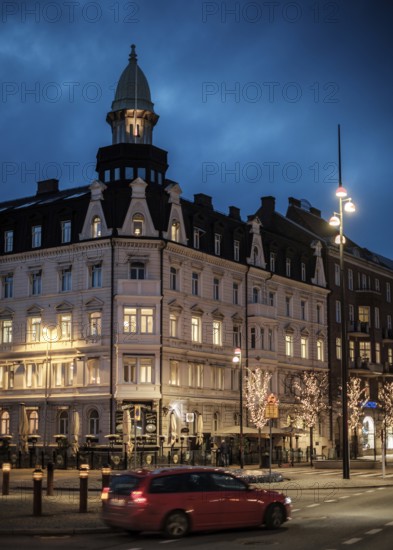 Historic building illuminated at night in a city area with streetlights in Helsingborg, Sweden,