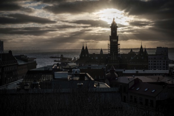 A silhouetted tower during sunset with a dramatic cloudscape and looking out to the Oresund Strait,