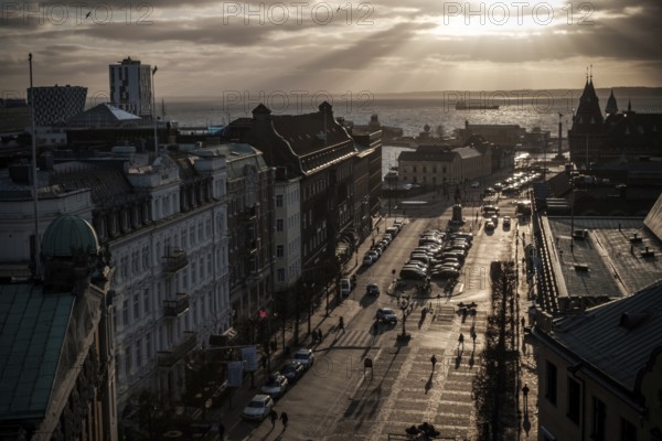 A street leading to the Oresund Strait under a dramatic sunset and clouds as seen from Helsingborg,