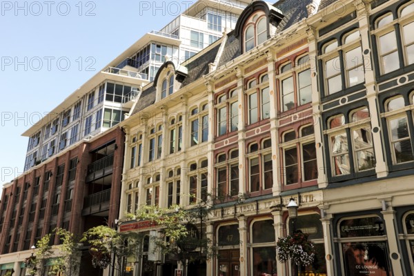 Row of historic buildings with ornate facades under a clear blue sky in Toronto, Ontario, Canada,