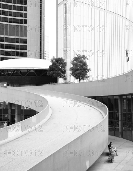 A curved ramp between modern buildings in a black and white setting in Toronto, Ontario, Canada,