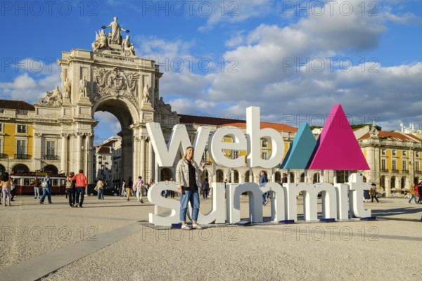 Nov 13, 2024 - Lisbon, Portugal: A female adult posing for a photo in front of Web Summit sign