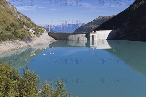 Waterfall bottom reservoir, dam wall, construction site, mountain panorama, energy industry, hiking