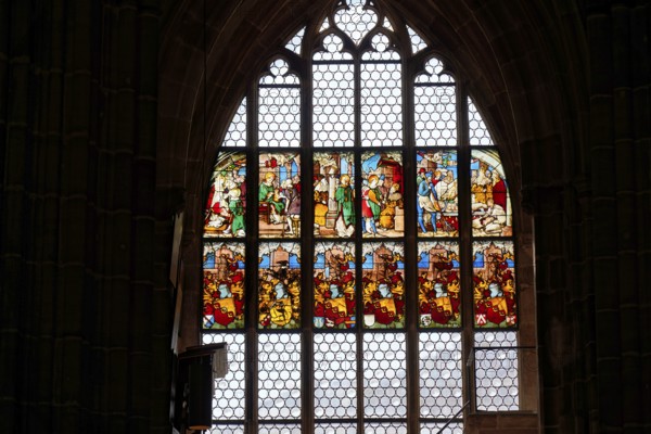 Large stained glass window depicting religious scenes in a Gothic church, Church of St. Lawrence,
