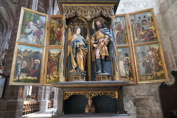 Historic altar with sculptures and religious paintings in a church, Church of St. Lawrence,