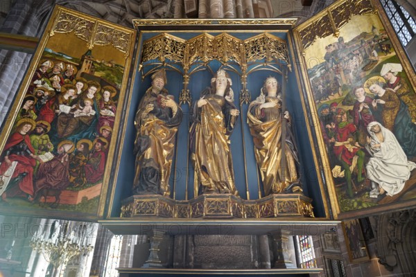 Ornate church altar with gilded figures of saints and colourful paintings, Church of St. Lawrence,