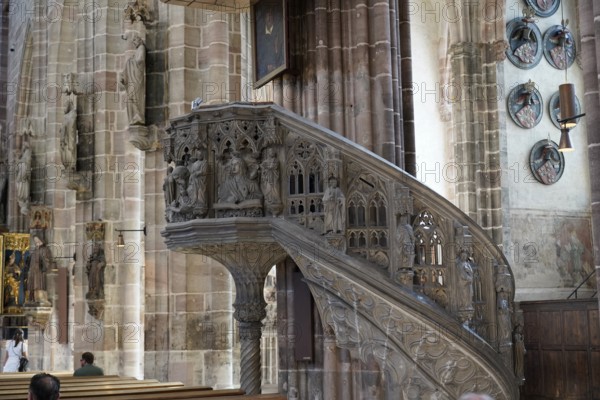 Detail of an ornately carved pulpit in an old church with depictions and figures, Church of St