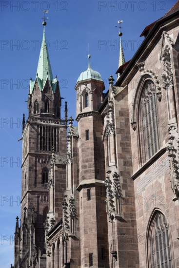 Gothic cathedral with high towers and decorated façade under a clear sky, Church of St Lawrence,