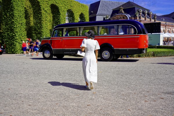 MERCEDES-BENZ 3500, built in 1950, retro bus in a park setting with a woman in the foreground,