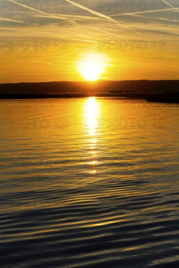 Lake Neusiedl, Burgenland, Austria, Europe, A magnificent sunset is reflected in the calm waters,