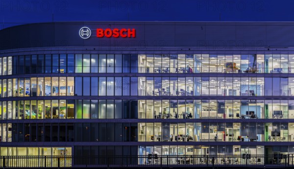 Modern office building of Bosch GmbH in Feuerbach at night with illuminated logo of the automotive