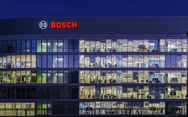 Modern office building of Bosch GmbH in Feuerbach at night with illuminated logo of the automotive