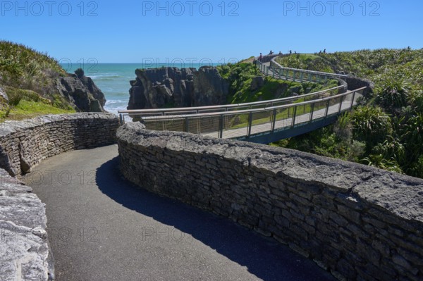 Extensive stone paths lead over a bridge past cliffs overlooking the sea, Pancake Rocks, Westport,