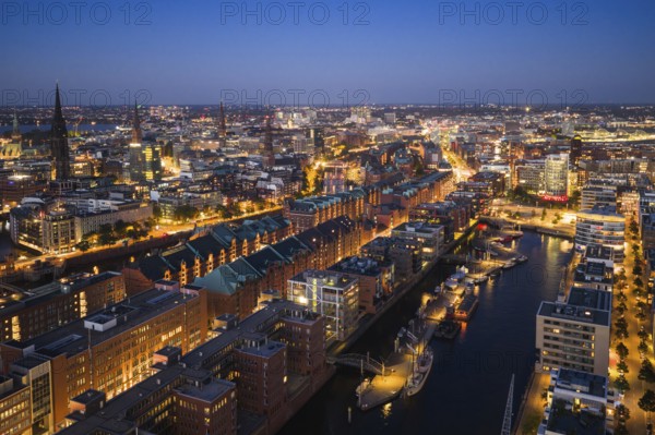 Aerial view of the historic warehouse district of Hamburg and Sandtor harbour at blue hour,