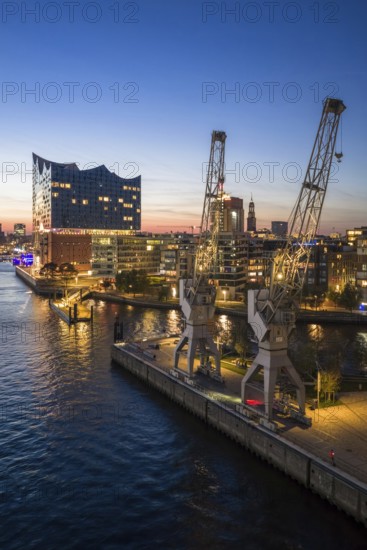 Aerial view of the Elbphilharmonie with Sandtorkai and historic cranes at the blue hour, Hamburg,