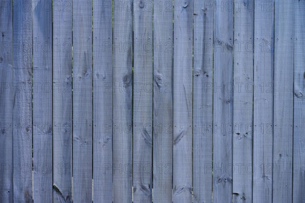 Close-up of a grey wooden fence with vertical panels and distinct texture, West Coast, South