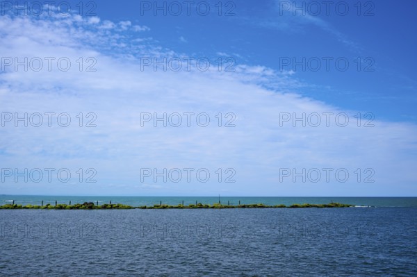 Sweeping view of the calm sea under a partly cloudy blue sky, Mana Bay, Patea, Taranaki, North