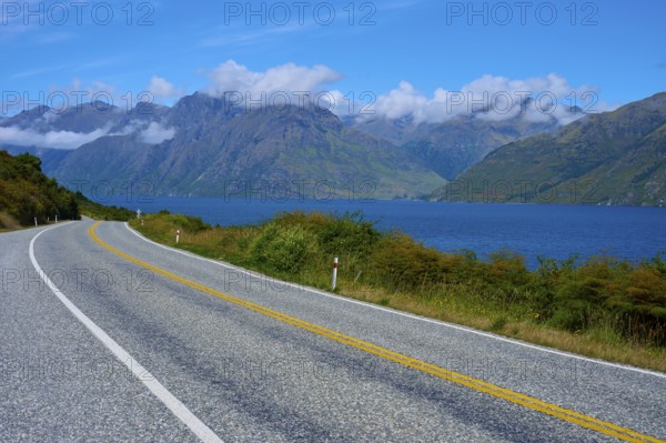 Winding road along a lake with mountains in the background, Devil's Staircase Lookout Point,