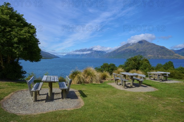 Picnic tables with a view of a lake and mountains below, Drift Bay, Lake Wakatipu, Queenstown-Lakes