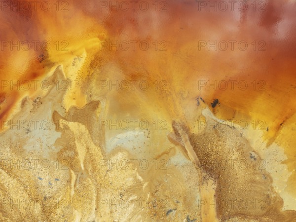 Abstract patterns in a pool in the mineral-rich area of the Rio Tinto mines. The colour is caused