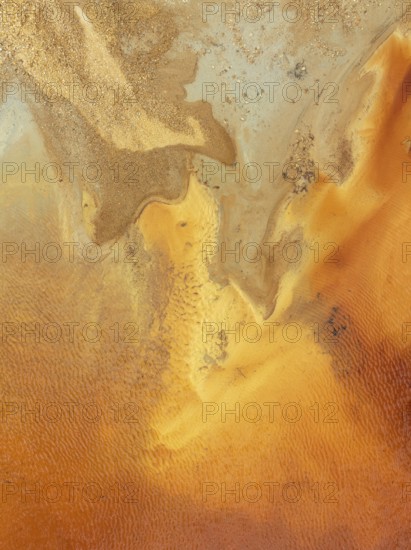 Abstract patterns in a pool in the mineral-rich area of the Rio Tinto mines. The colour is caused