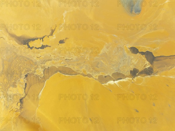 Abstract patterns in a waste pond in the mineral-rich area of the Rio Tinto mines. The colour is