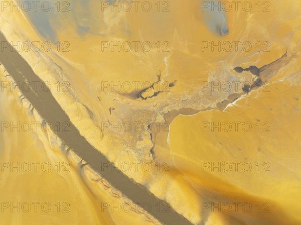 Abstract patterns in a waste pond in the mineral-rich area of the Rio Tinto mines. The colour is