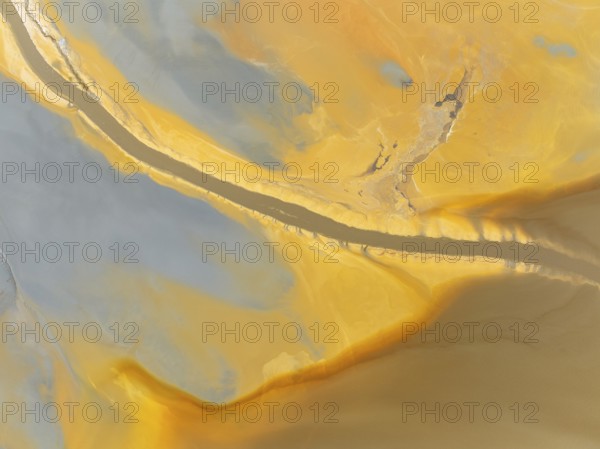 Abstract patterns in a waste pond in the mineral-rich area of the Rio Tinto mines. The colour is