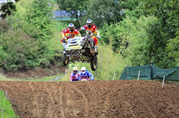 Motocross, Rudersberg, Baden-Württemberg, Germany, Europe, Rider team flies with a motorbike with