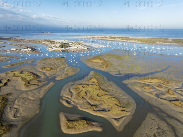 Network of channels and streams at low tide and the fishing village of Sancti Petri at the Atlantic