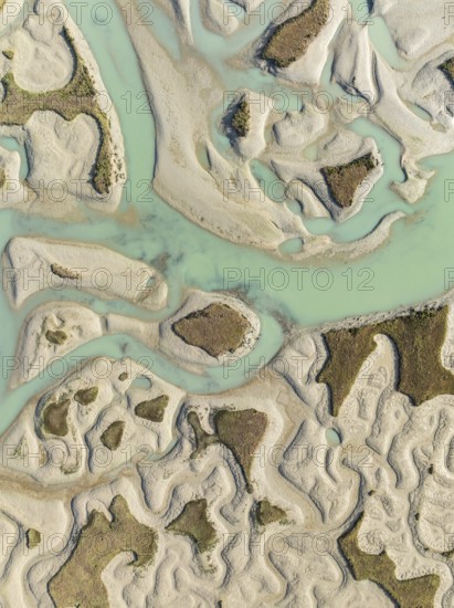 Network of channels and streams at low tide. In the marshland of the Bahía de Cádiz Nature Reserve.