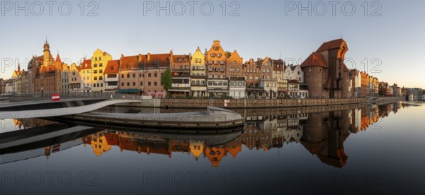 Panorama of the waterfront promenade with reflection at sunrise in the Old Town, Motlawa River,
