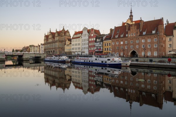 Waterfront promenade with reflection at sunrise in the Old Town, Motlawa River, Gdansk, Gdansk,