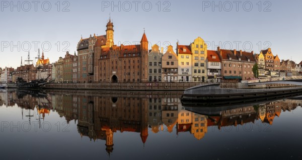 Panorama of the waterfront promenade with reflection at sunrise in the Old Town, Motlawa River,