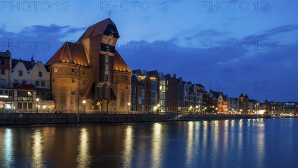 Illuminated waterfront promenade at sunset in the Old Town, Brama Zuraw crane gate, Motlawa River,