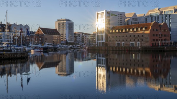 Waterfront promenade with reflection at sunrise in the Old Town, Motlawa River, Gdansk, Gdansk,