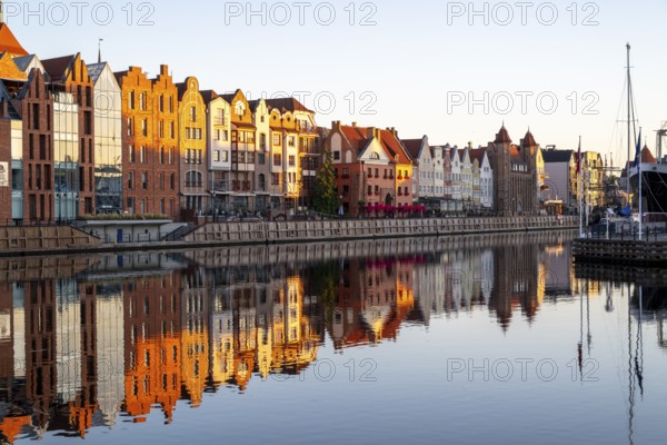 Waterfront promenade with reflection at sunrise in the Old Town, Motlawa River, Gdansk, Gdansk,