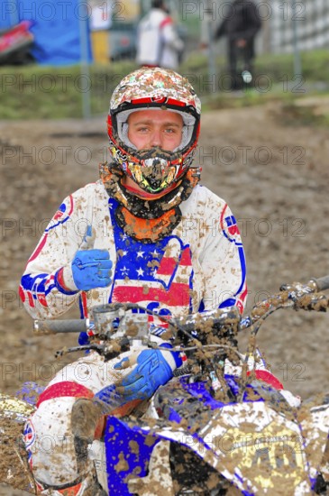 Motocross, Rudersberg, Baden-Württemberg, Germany, Europe, Motocross rider in muddy clothes gives