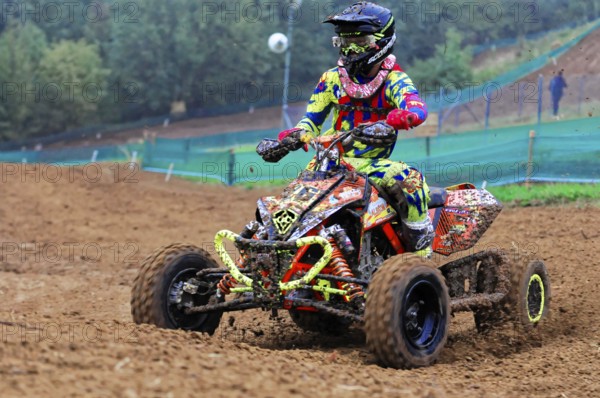 Motocross, Rudersberg, Baden-Württemberg, Germany, Europe, Colourful quad bike rider rides through