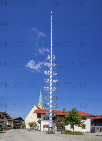 Parish Church of the Assumption of the Virgin Mary with maypole and town hall on the village