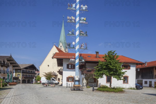 Parish Church of the Assumption of the Virgin Mary with maypole and town hall on the village