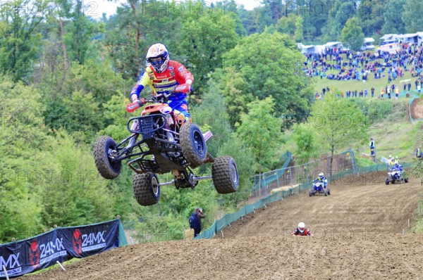 Motocross, Rudersberg, Baden-Württemberg, Germany, Europe, A quadbike drives in the air over a