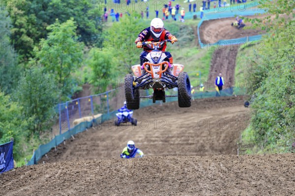 Motocross, Rudersberg, Baden-Württemberg, Germany, Europe, A quad bike rider jumps over a track