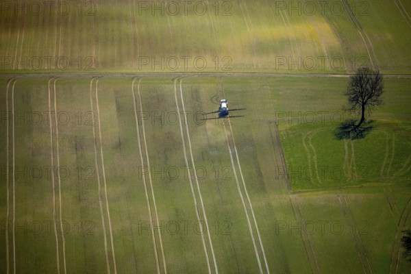 Aerial view, slurry tractor on a field during slurry spraying, emission, in Lichtenfels in Hesse.