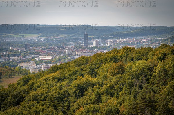 Jena city centre with a striking high-rise building Jentower, surrounded by forests under a grey