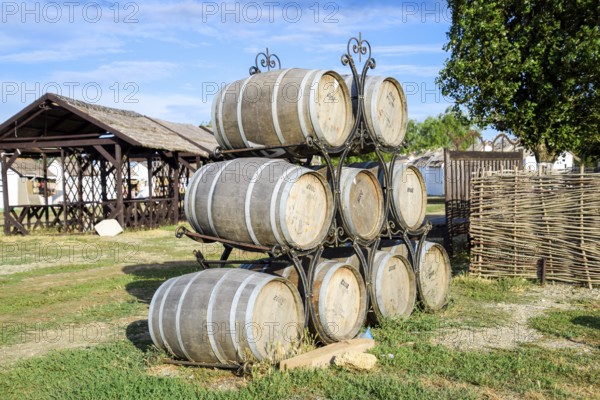Stacked wine barrels. Decoration of the barrels in the village Ataman. Taman, Krasnodar Krai,