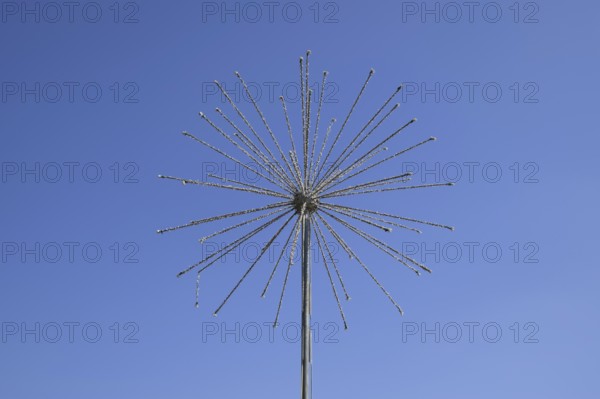 Street lamp in the form of fireworks. Garlands on a steel frame in the shape of a ball fireworks.